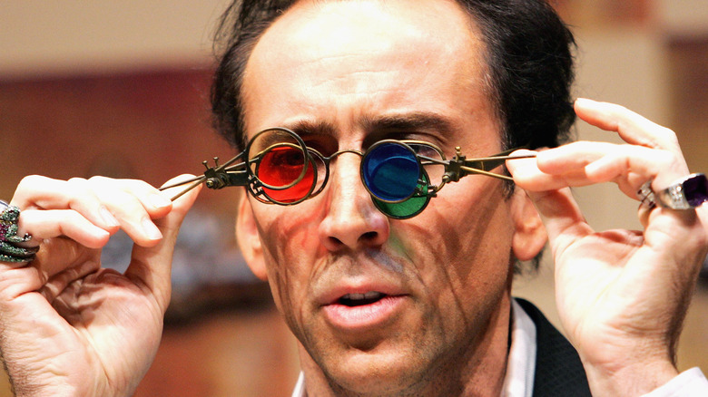 Nic Cage plays with prop glasses