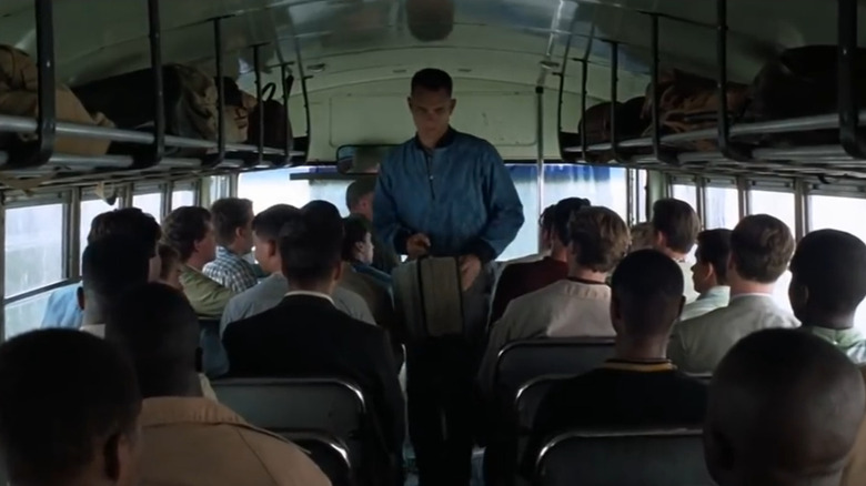 Tom Hanks walks through a bus