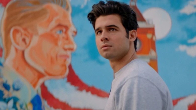 Cameron with a mural of his father