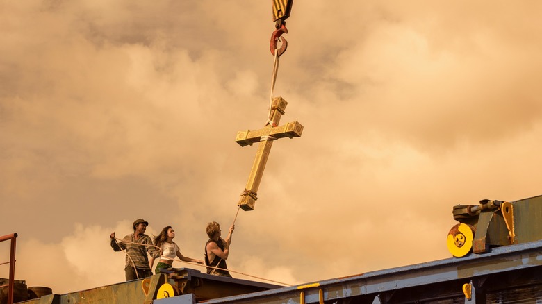 Outer Banks cast gold cross crane