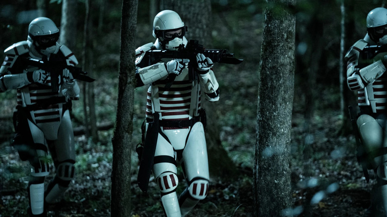 Commonwealth Army soldiers running through woods