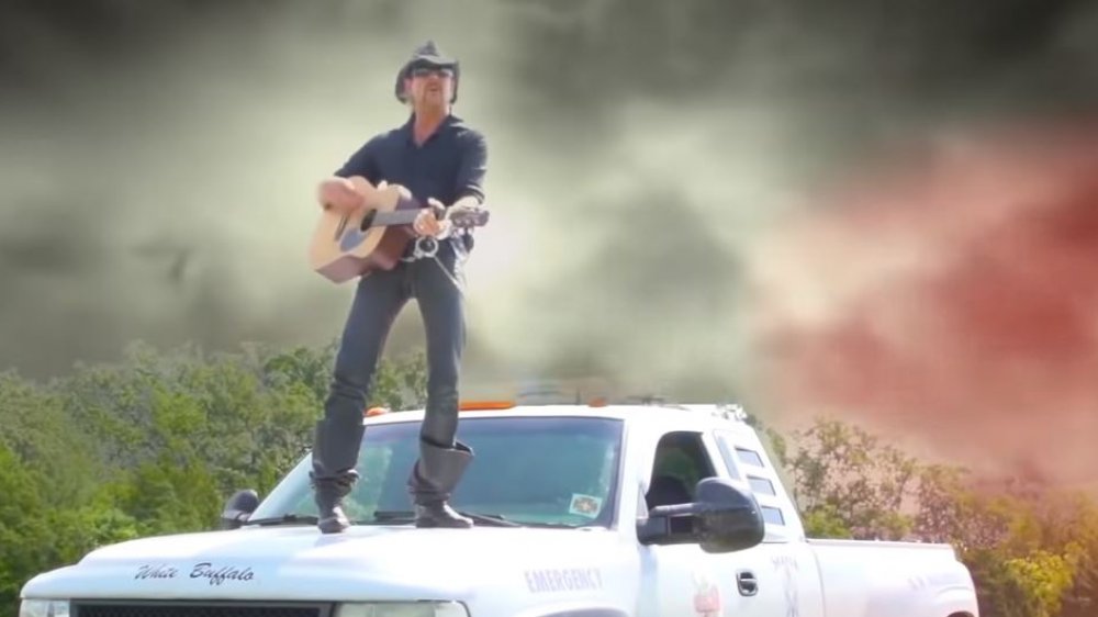 Joe Exotic singing on top of a truck on Tiger King