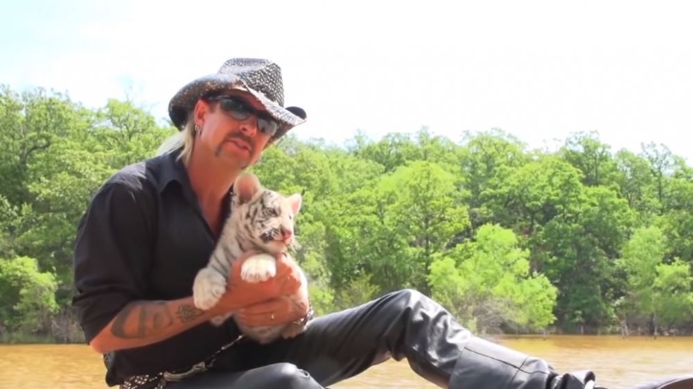 Joe Exotic holding tiger cub on Netflix's Tiger King