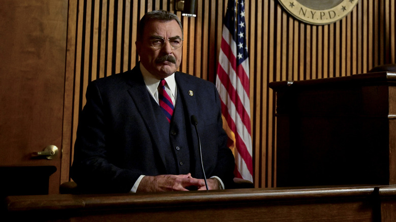 Frank Reagan wearing a red and blue tie