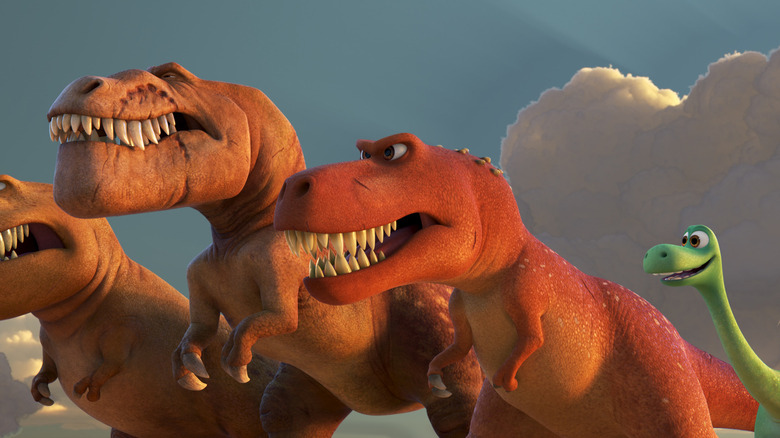 Arlo with a trio of T-rexes