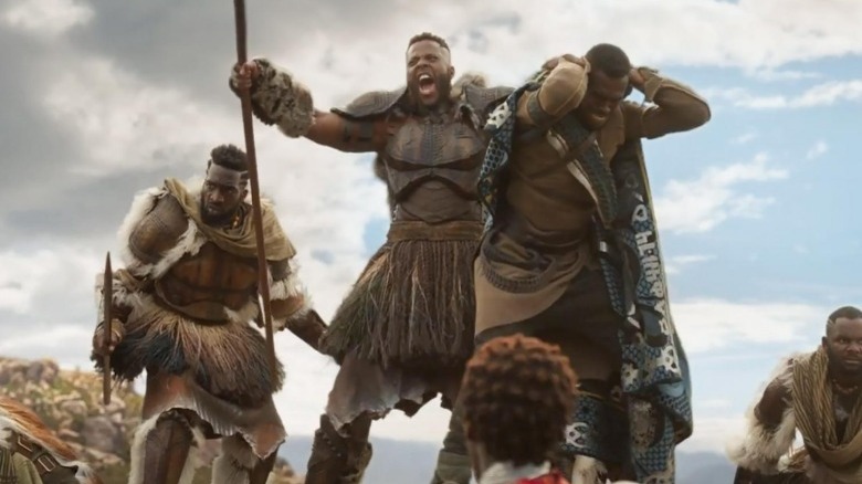 M'Baku holding up a Wakandan by their collar