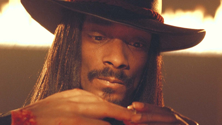 Snoop Dogg in Bones holding a severed hand