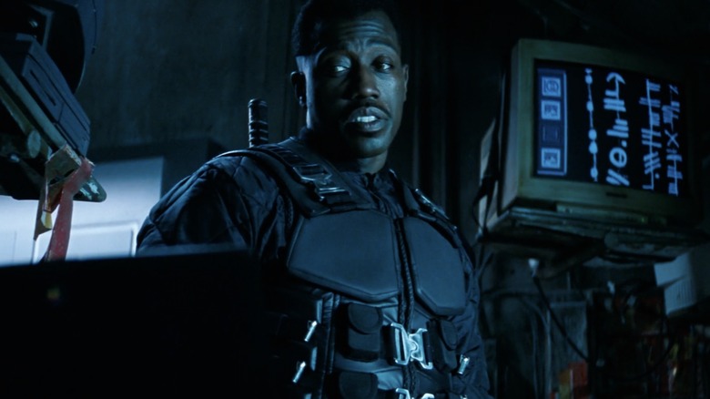 Wesley Snipes with eyebrows raised, looking at a computer monitor