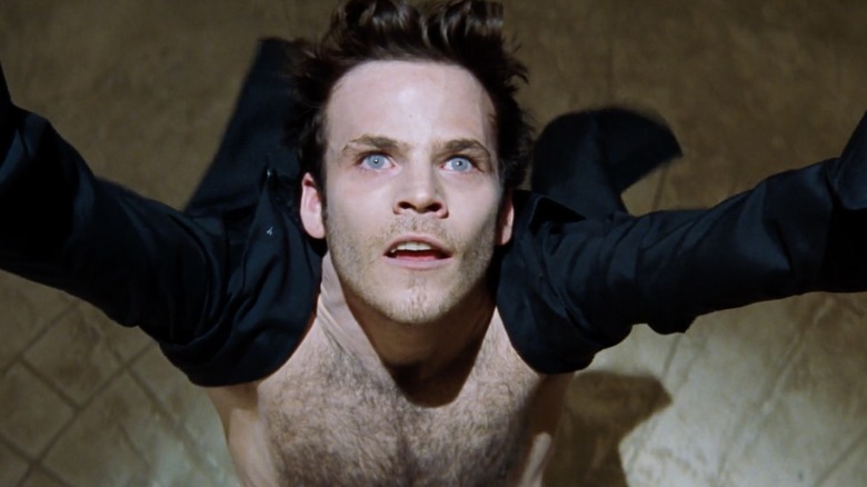 Stephen Dorff as Deacon Frost raising his arms and looking up toward a light