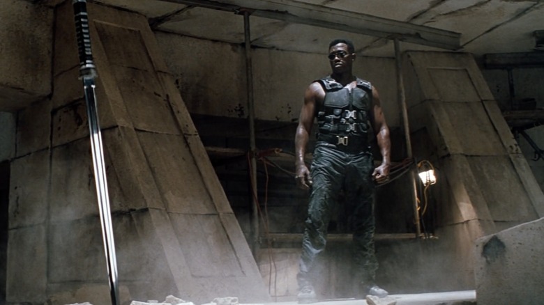 Wesley Snipes in Blade, staring intently a sword stuck in the floor of a temple chamber