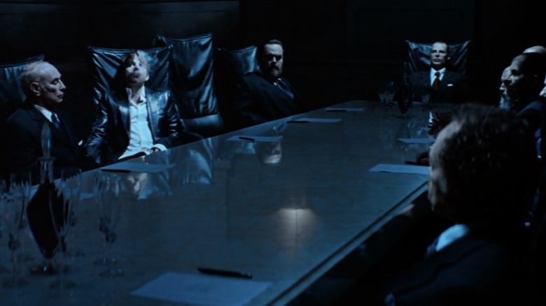 Stephen Dorff's Deacon Frost with the Vampire Council, seven men in leather chairs around a conference table