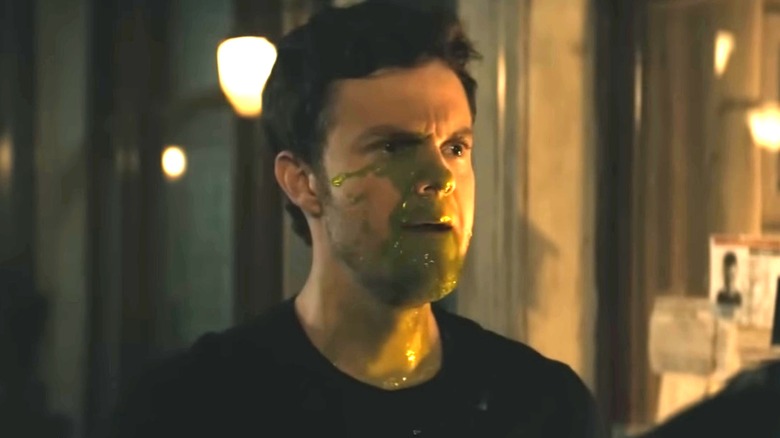 Hughie covered in green vomit