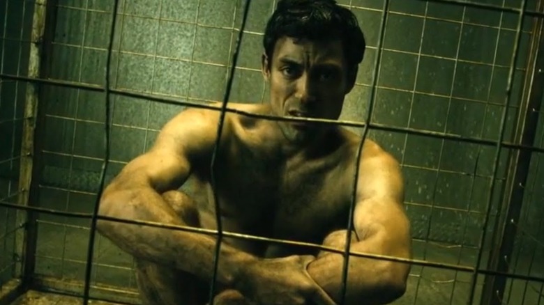 Translucent sits naked in cell