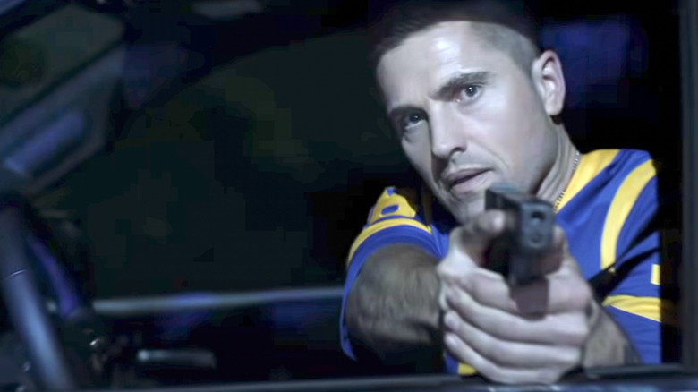 Eric Winter pointing a gun