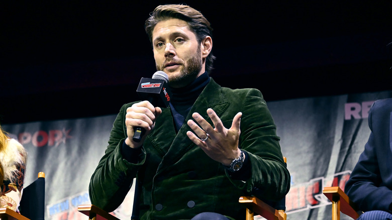 Jensen Ackles holding microphone