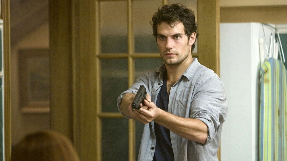 Henry Cavill pointing a gun