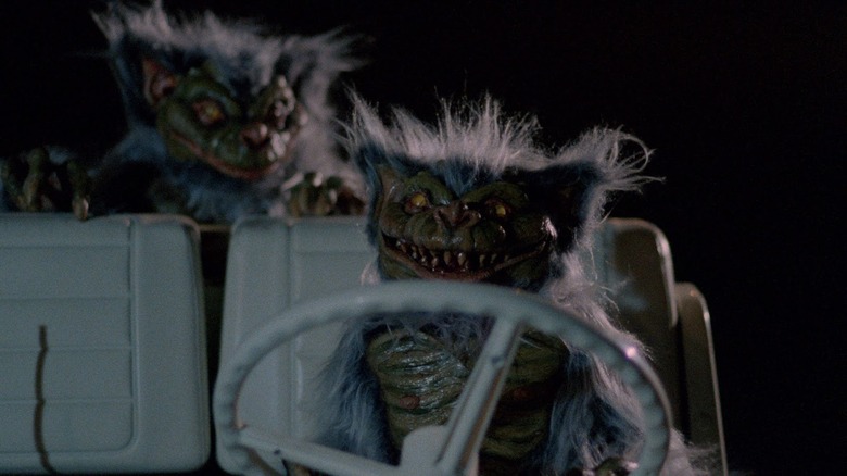 two hobgoblins riding a golf cart