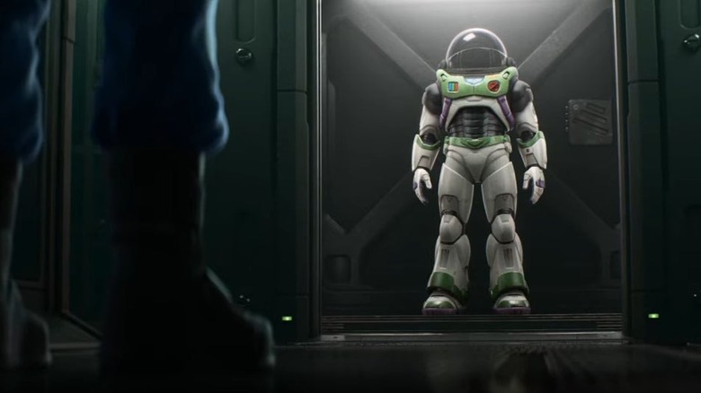 Buzz looking at space suit