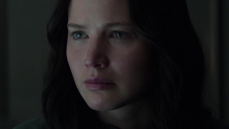 Katniss frowning, her eyes glassy