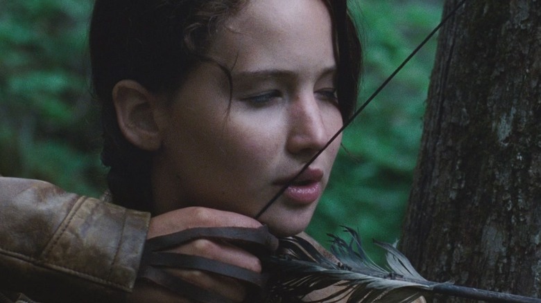 Katniss, eyed closed, aiming an arrow