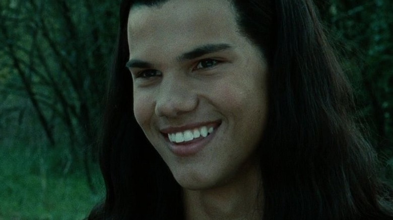 Jacob, with long hair, smiling