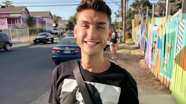 Shane Next to Colorful Fence