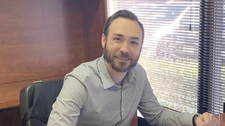 Michael Adam Royer smiling at desk