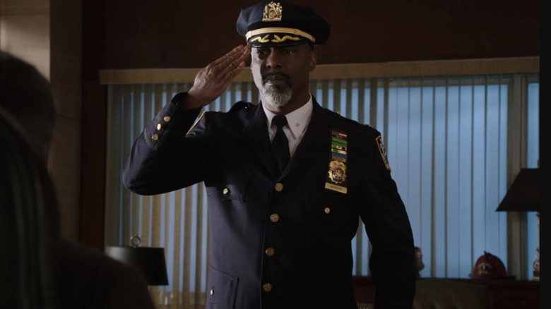 Isaiah Washington in a police uniform 