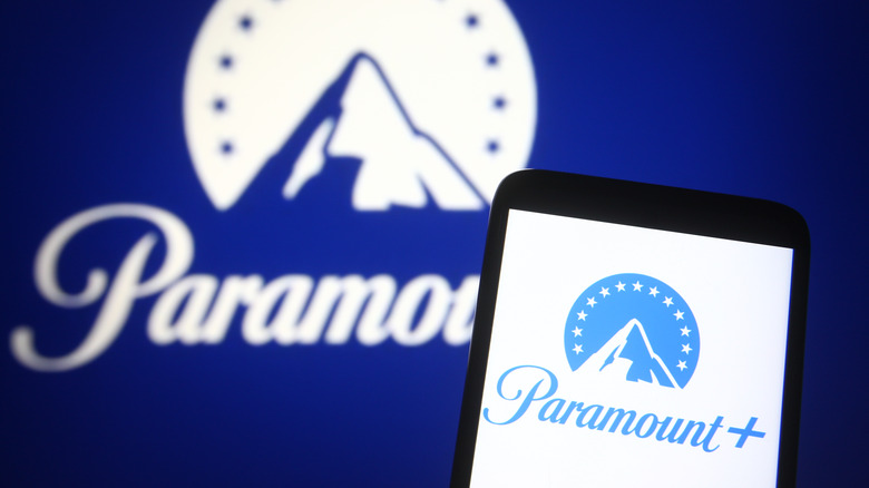 Paramount+ logo on phone in front of Paramount logo