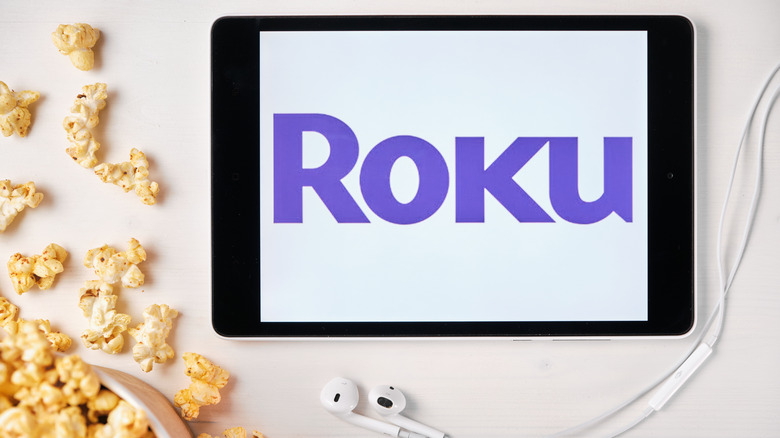 Roku logo on tablet surrounded by popcorn