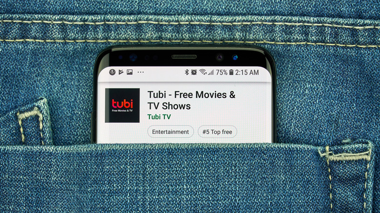 Tubi app purchase on phone in jean pocket