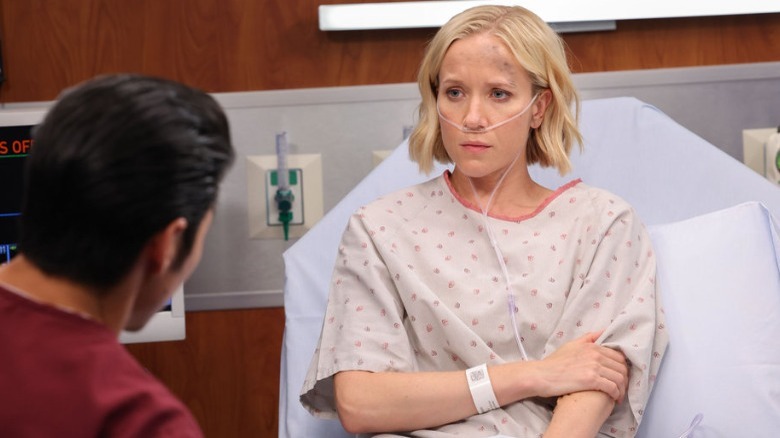 Jessy Schram sitting in hospital bed