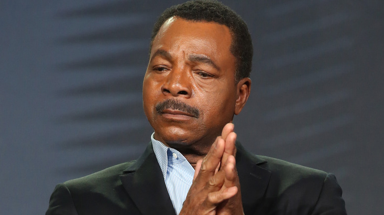 Carl Weathers clasping his hands