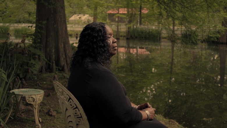 Woman sitting by lake