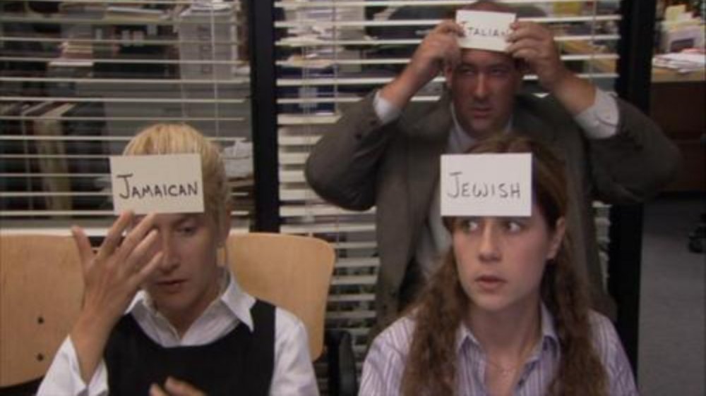 Angela (Angela Kinsey), Pam (Jenna Fischer), and Kevin (Brian Baumgartner) attach cards to their heads on The Office