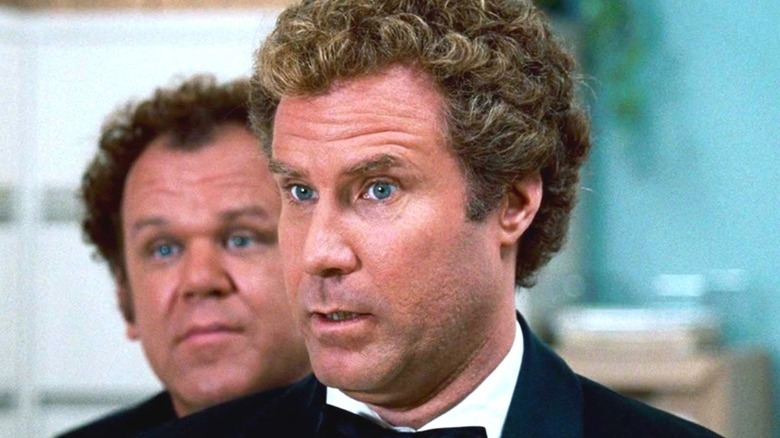 John C. Reilly looking over Will Ferrell's shoulder