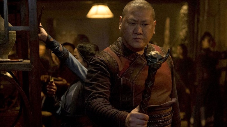 Benedict Wong holding staff