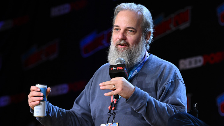 Dan Harmon holding a microphone 