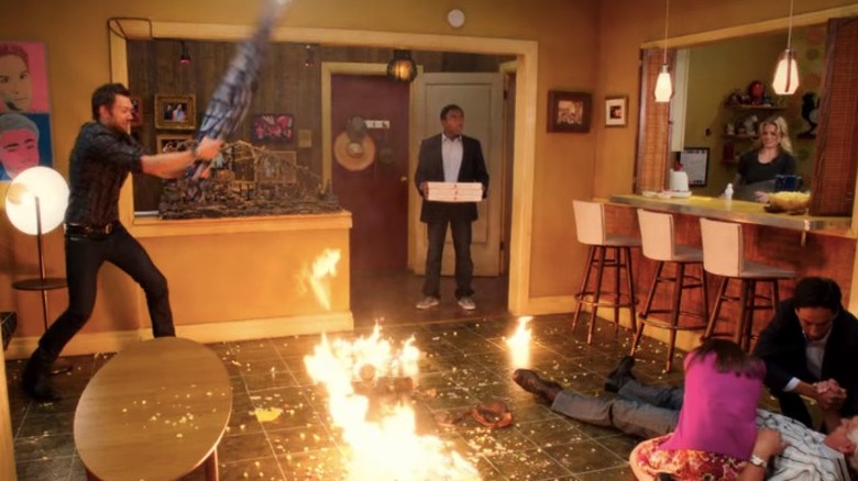 The characters of Community putting out a fire