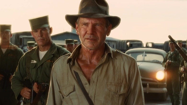 Indiana Jones flanked by soldiers