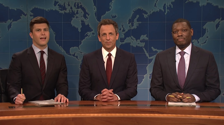 Colin Jost, Seth Meyers, and Michael Che at desk