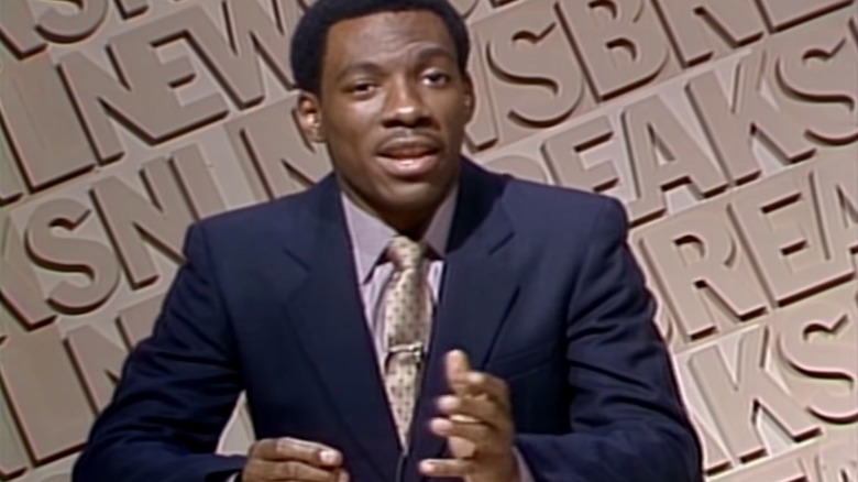 Eddie Murphy talking in suit