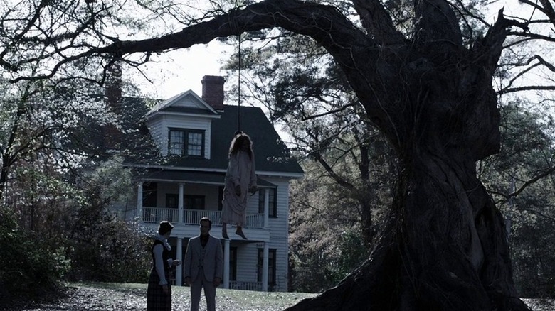 Ed and Lorraine beneath hanging body