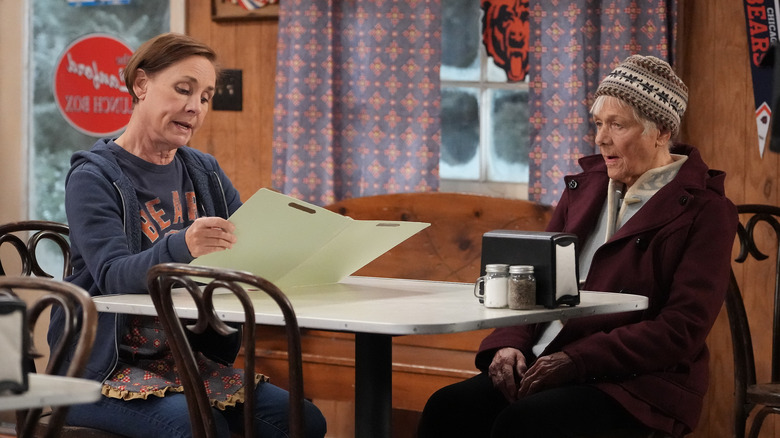 Jackie and Beverly Harris looking serious at table