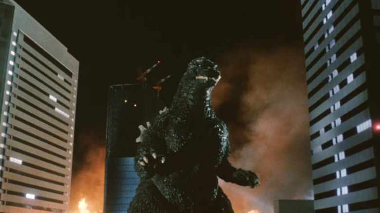 Godzilla walking by buildings