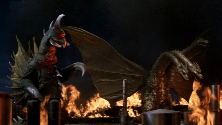 Gigan and Ghidorah above flames