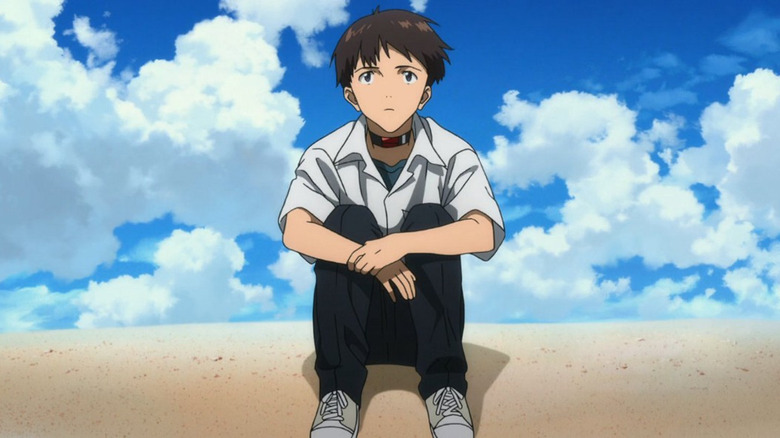 Shinji sits on the beach