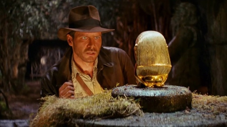 Indiana Jones eying a relic