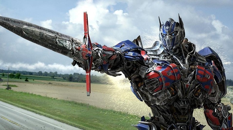 Optimus Prime holding a sword on the road