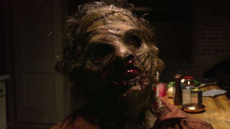 Leatherface looking up while sitting